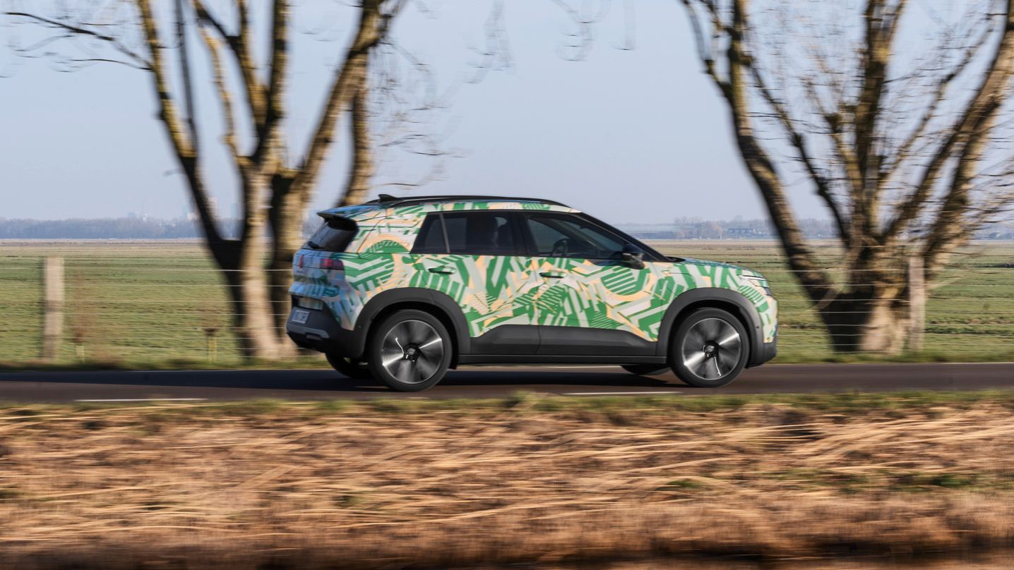 Um VW ID. Cross visto de perfil a circular numa estrada rural.