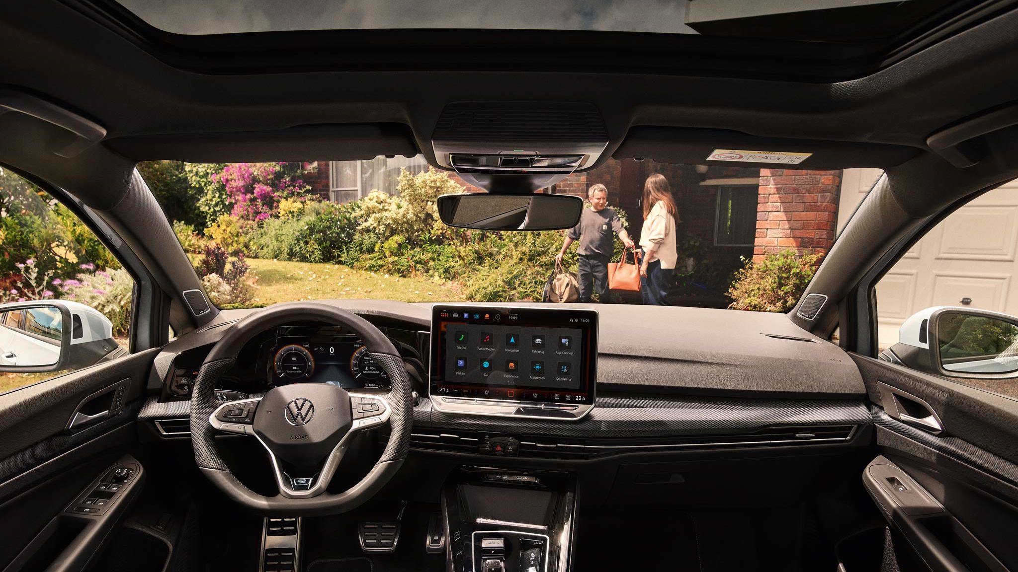 Innenansicht auf den vorderen Bereich des VW Golf Estate mit Lenkrad, großem Bildschirm und der Mittelkonsole.