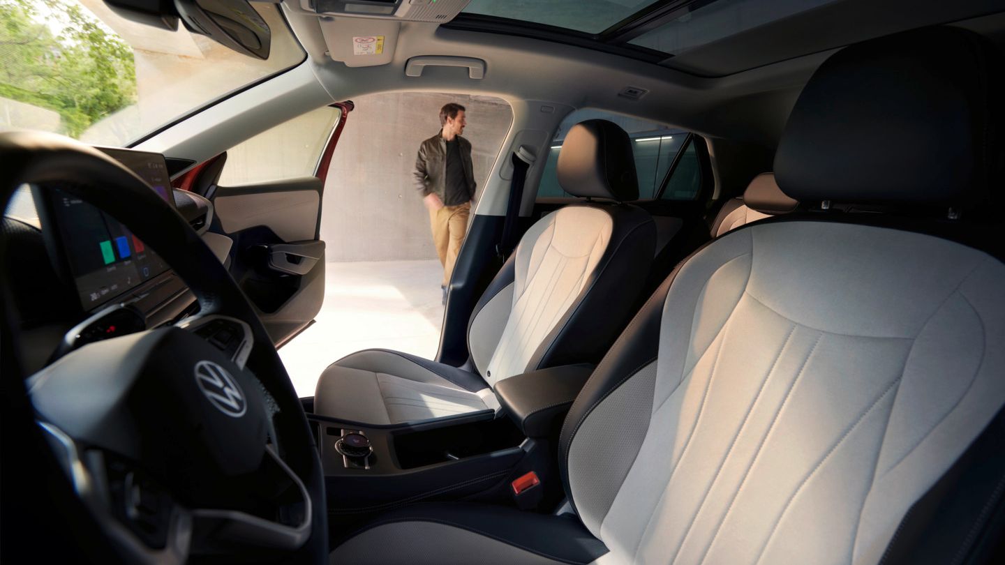 Vista através da porta do condutor do VW T-Roc Style para o interior com bancos claros.