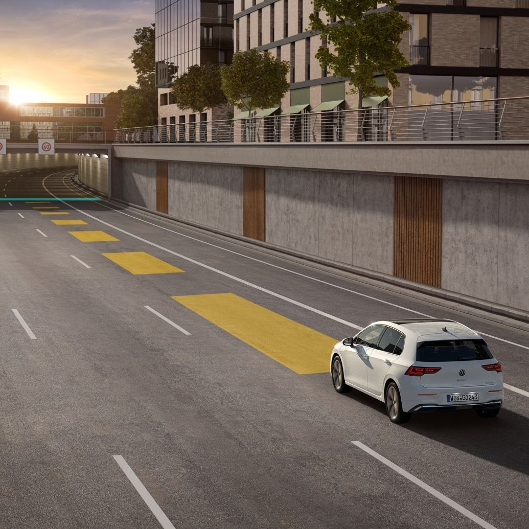 Weißer VW Golf bewegt sich im Straßenverkehr, dabei wird die automatische Distanzregelung ACC genutzt.